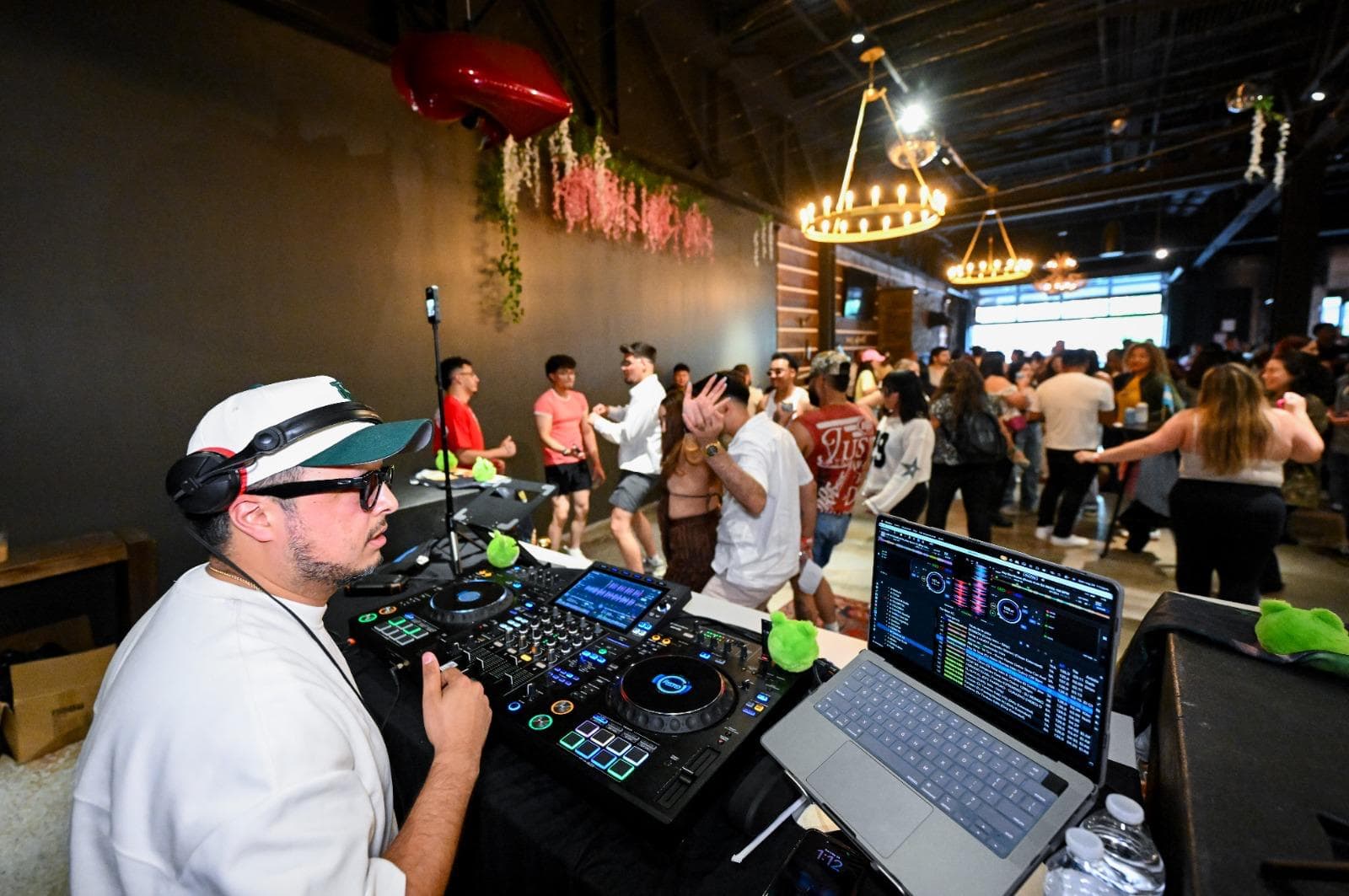 The DJ working the booth as the floor fills