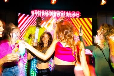 Cheers in the neon-lit cabana lounge