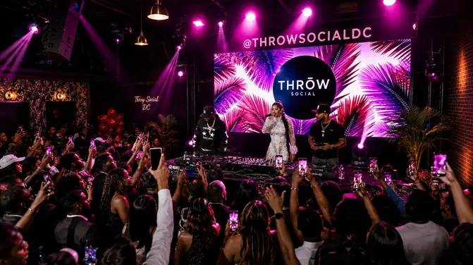 Guests on the floor in front of the lit stage